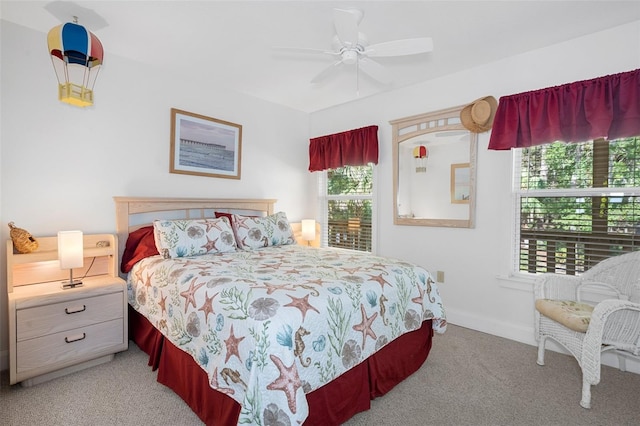 bedroom featuring baseboards, ceiling fan, and light colored carpet