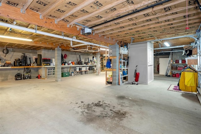 garage featuring a workshop area and a garage door opener