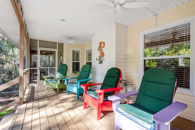 wooden deck with a ceiling fan