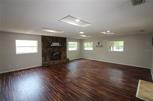 unfurnished living room featuring baseboards, visible vents, and wood finished floors