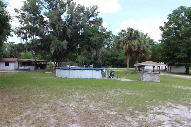 view of yard featuring a gazebo and an outdoor pool