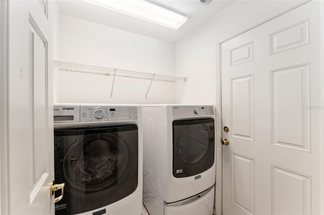 clothes washing area featuring laundry area and separate washer and dryer