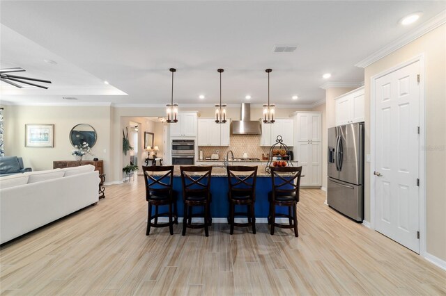 10445 SW 90th Street Rd, Ocala, FL 34481 - kitchen with stainless steel appliances, wall chimney exhaust hood, open floor plan, a kitchen breakfast bar, and recessed lighting