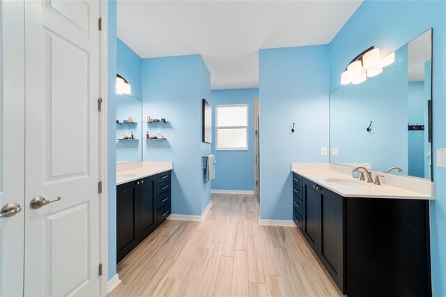 10445 SW 90th Street Rd, Ocala, FL 34481 - bathroom featuring two vanities, wood finished floors, and baseboards