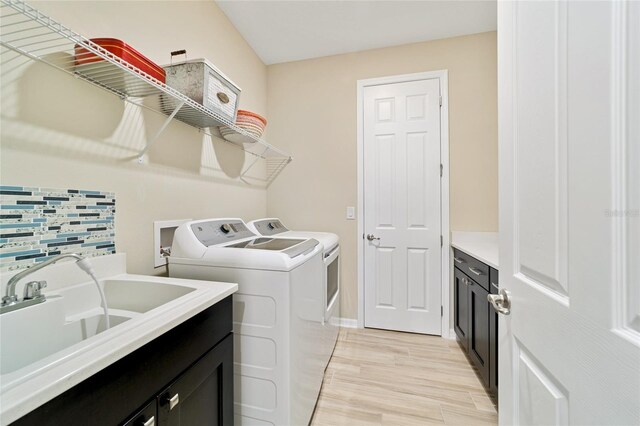 10445 SW 90th Street Rd, Ocala, FL 34481 - washroom featuring separate washer and dryer, cabinet space, and baseboards