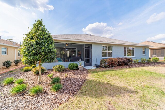 10445 SW 90th Street Rd, Ocala, FL 34481 - back of house featuring a sunroom, a lawn, and stucco siding