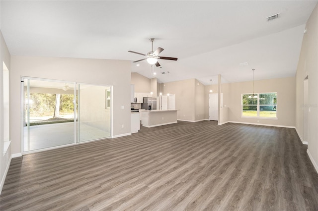 unfurnished living room with vaulted ceiling, baseboards, visible vents, a ceiling fan, and wood finished floors