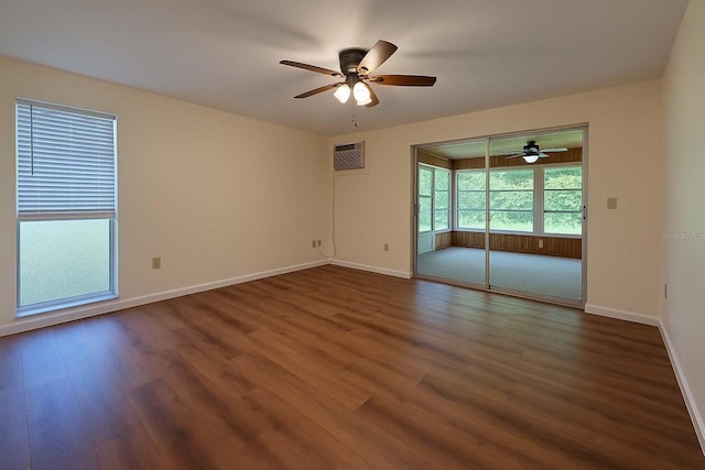 12180 Maple St, Dunnellon, FL 34432 - unfurnished room with a ceiling fan, dark wood finished floors, baseboards, and a wall mounted air conditioner