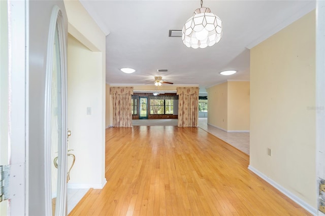12180 Maple St, Dunnellon, FL 34432 - entryway featuring baseboards, light wood-style flooring, a ceiling fan, and crown molding