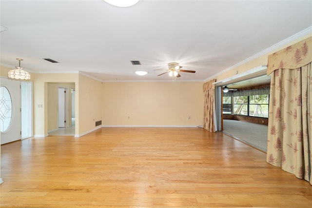 12180 Maple St, Dunnellon, FL 34432 - spare room featuring ornamental molding, light wood-style floors, ceiling fan, baseboards, and a chandelier