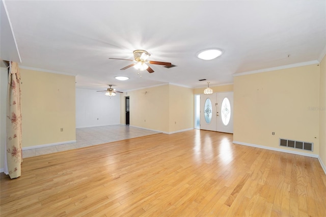 12180 Maple St, Dunnellon, FL 34432 - unfurnished living room featuring light wood-style floors, ceiling fan, baseboards, and ornamental molding