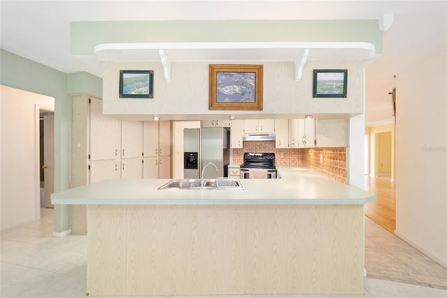 12180 Maple St, Dunnellon, FL 34432 - kitchen with appliances with stainless steel finishes, a sink, light countertops, tasteful backsplash, and light tile patterned flooring