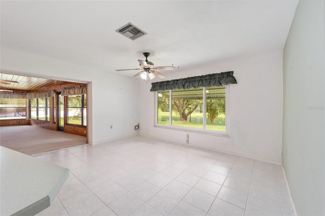 12180 Maple St, Dunnellon, FL 34432 - empty room with ceiling fan, baseboards, and light tile patterned flooring