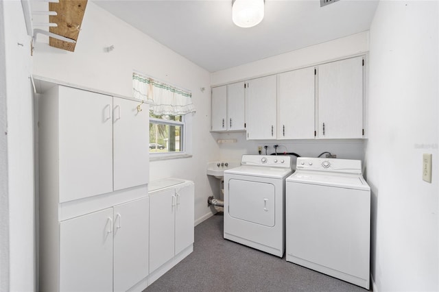 12180 Maple St, Dunnellon, FL 34432 - laundry area with cabinet space, washing machine and clothes dryer, baseboards, and carpet flooring