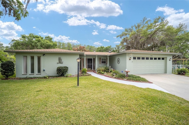 12180 Maple St, Dunnellon, FL 34432 - view of front facade featuring stucco siding, an attached garage, concrete driveway, and a front lawn