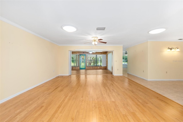 12180 Maple St, Dunnellon, FL 34432 - unfurnished living room featuring ornamental molding, light wood-style floors, and a ceiling fan
