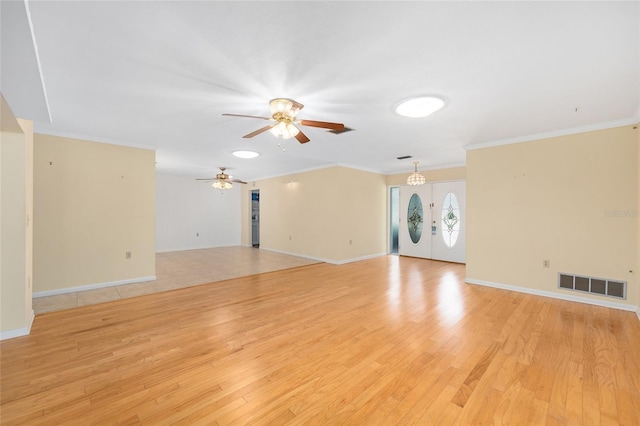 12180 Maple St, Dunnellon, FL 34432 - unfurnished living room featuring light wood-type flooring, ceiling fan, and crown molding