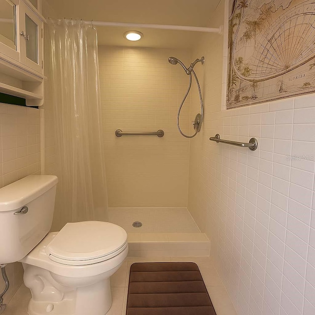 12180 Maple St, Dunnellon, FL 34432 - full bath with a stall shower, tile walls, and tile patterned flooring