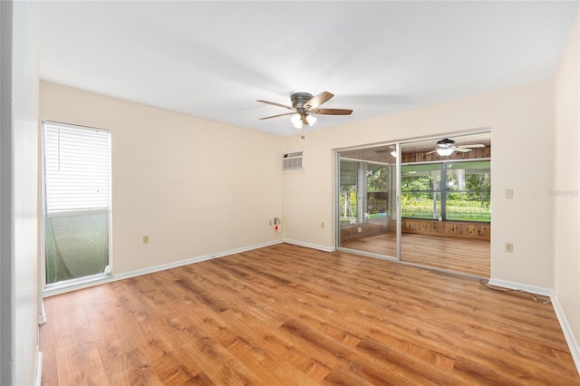 12180 Maple St, Dunnellon, FL 34432 - spare room featuring ceiling fan, a wall unit AC, and light wood-style flooring