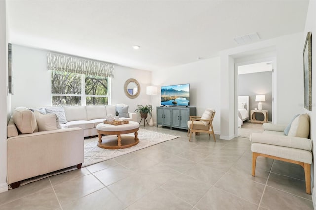 living room featuring light tile patterned flooring and visible vents