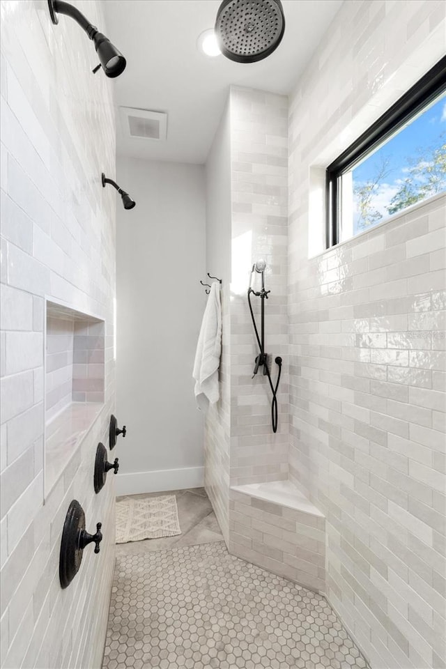 5024 N Tumblewood Dr, Crystal River, FL 34428 - bathroom featuring baseboards, visible vents, a tile shower, and tile patterned flooring