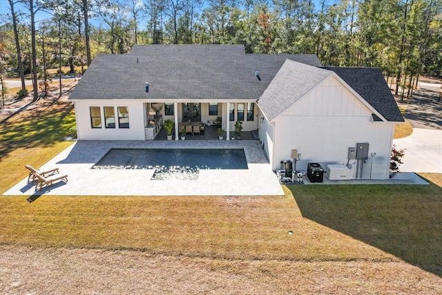 5024 N Tumblewood Dr, Crystal River, FL 34428 - back of house with roof with shingles, a yard, and a patio