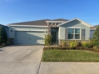 ranch-style house featuring driveway and an attached garage