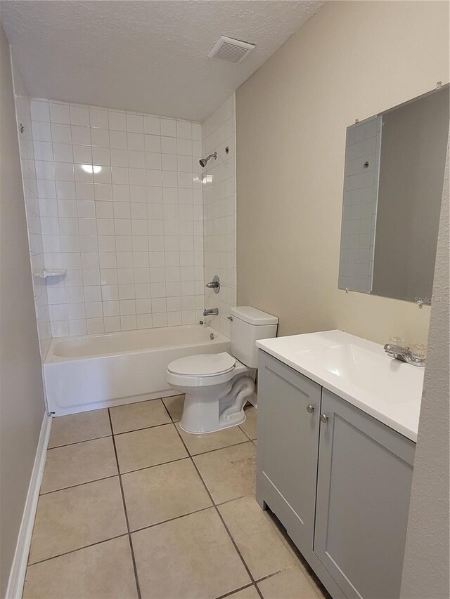 707/709 NE 26th St, Ocala, FL 34470 - bathroom with a textured ceiling, visible vents, toilet, tile patterned floors, and shower / washtub combination