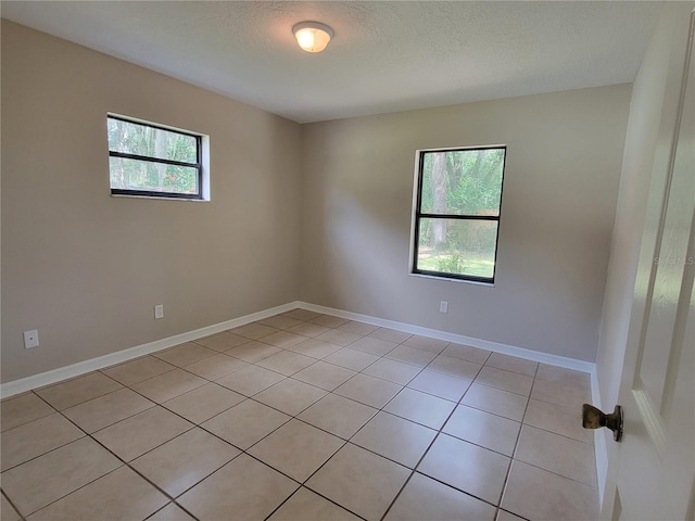 707/709 NE 26th St, Ocala, FL 34470 - spare room with baseboards and a textured ceiling