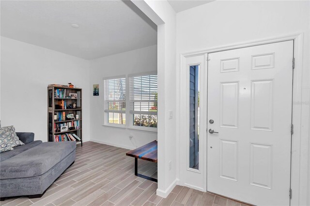 9312 SW 58th Cir, Ocala, FL 34476 - foyer entrance featuring baseboards and light wood finished floors