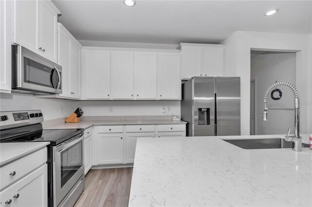 9312 SW 58th Cir, Ocala, FL 34476 - kitchen featuring stainless steel appliances, a sink, white cabinets, and recessed lighting