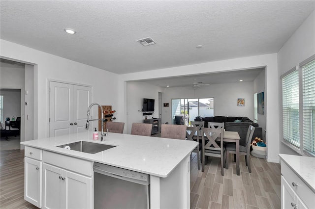 9312 SW 58th Cir, Ocala, FL 34476 - kitchen with dishwasher, a sink, light wood-style floors, white cabinetry, and open floor plan