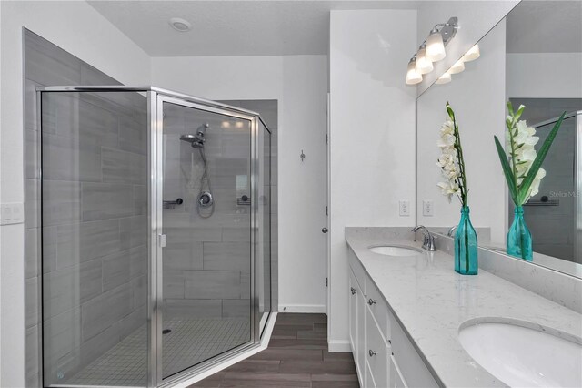 9312 SW 58th Cir, Ocala, FL 34476 - bathroom featuring double vanity, a stall shower, wood finished floors, and baseboards