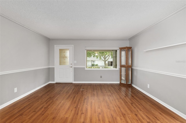 8645 SW 94th Ln Unit E, Ocala, FL 34481 - empty room with ornamental molding, wood finished floors, and a textured ceiling