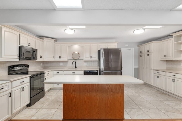 8645 SW 94th Ln Unit E, Ocala, FL 34481 - kitchen with tasteful backsplash, open shelves, black appliances, a center island, and a sink