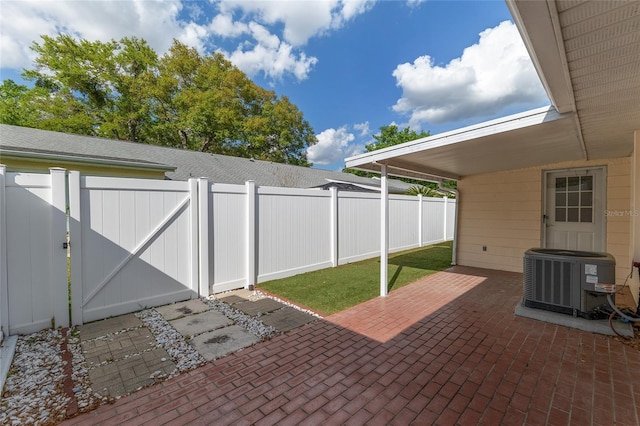 8645 SW 94th Ln Unit E, Ocala, FL 34481 - view of patio / terrace with central air condition unit, fence, and a gate
