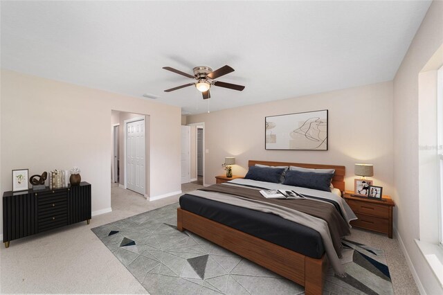 bedroom with baseboards, carpet floors, visible vents, and a ceiling fan