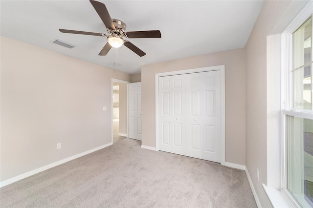unfurnished bedroom with baseboards, visible vents, a closet, and carpet