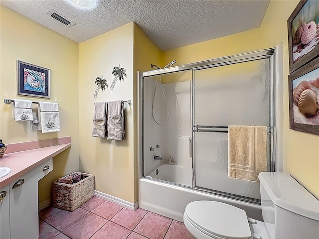 916 Cancun Ct, Lady Lake, FL 32159 - bathroom with a textured ceiling, visible vents, toilet, enclosed tub / shower combo, and tile patterned flooring