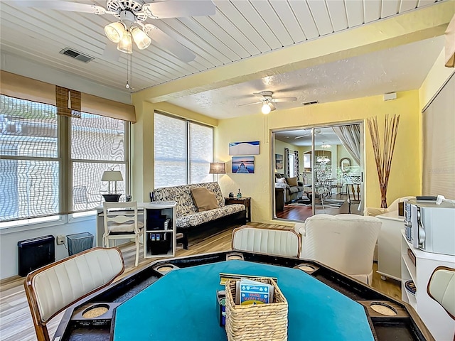 916 Cancun Ct, Lady Lake, FL 32159 - living room featuring a ceiling fan, wood finished floors, beamed ceiling, and visible vents