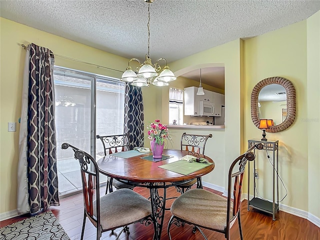 916 Cancun Ct, Lady Lake, FL 32159 - dining room featuring a textured ceiling, a chandelier, and wood finished floors