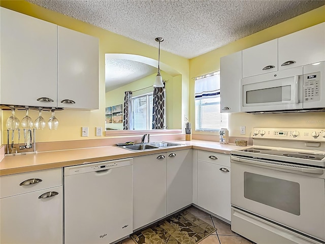 916 Cancun Ct, Lady Lake, FL 32159 - kitchen with light countertops, white appliances, a textured ceiling, a sink, and white cabinets