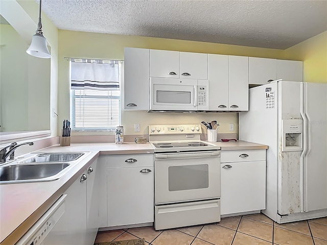 916 Cancun Ct, Lady Lake, FL 32159 - kitchen with light countertops, white cabinets, white appliances, a sink, and light tile patterned floors