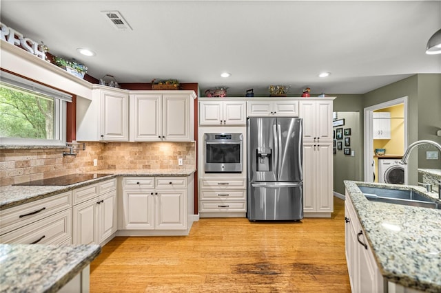 5118 SW 197th Ter, Dunnellon, FL 34431 - kitchen featuring appliances with stainless steel finishes, a sink, light wood-style flooring, white cabinetry, and recessed lighting