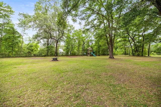 5118 SW 197th Ter, Dunnellon, FL 34431 - view of grassy yard with a playground and a fire pit