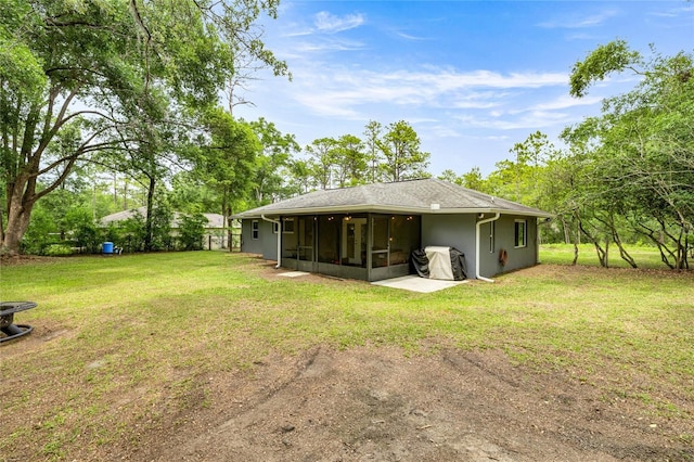 5118 SW 197th Ter, Dunnellon, FL 34431 - rear view of house featuring a sunroom and a lawn