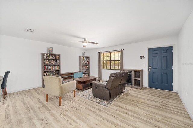 6549 NW 65th Pl, Ocala, FL 34482 - living room with baseboards, light wood-style flooring, and a ceiling fan