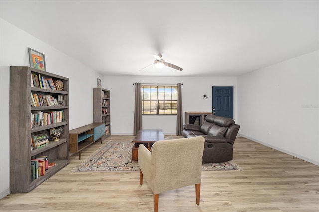 6549 NW 65th Pl, Ocala, FL 34482 - living room with baseboards, light wood-style floors, and ceiling fan