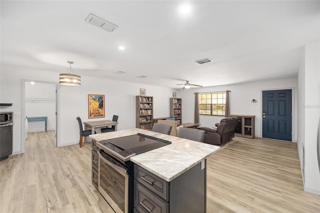 6549 NW 65th Pl, Ocala, FL 34482 - kitchen featuring a ceiling fan, a center island, light wood-style flooring, stainless steel appliances, and visible vents