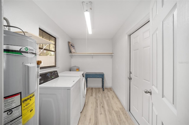 6549 NW 65th Pl, Ocala, FL 34482 - washroom featuring electric water heater, laundry area, separate washer and dryer, and light wood-type flooring